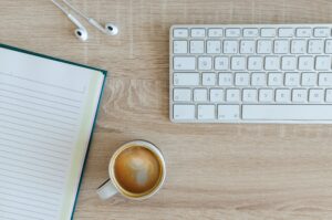 a coffee and keyboard on a desk perfect for writing vegan guest posts